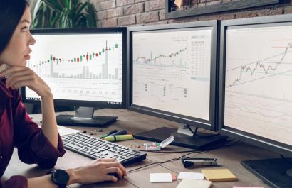 Analysis of stock markets, comparison of currency with bitcoin. Indoor, studio shot. Business people concept, work in office