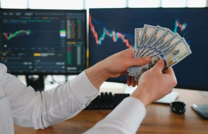 Holding Dollar bills in the stock market. Investors counting money after making it big on the stock market. becoming rich and wealthy. online stock market information