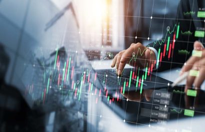 Investors use laptops to analyze stock market, investment strategies. and business growth analysis, investing in companies with long-term competitive advantages, against the backdrop of the city.