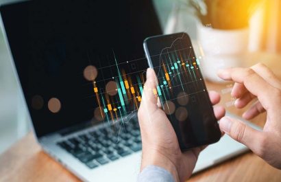 Businessmen investor think before buying stock market investment using smartphone to analyze trading data. trader is showing a growing virtual hologram stock on smartphone. Financial stock market.
