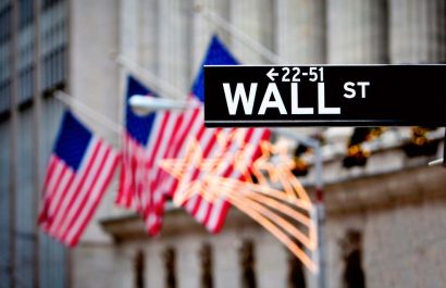 Wall street sign in New York with New York Stock Exchange background